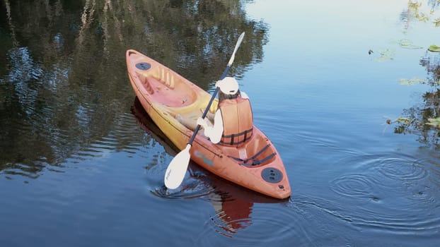 Back young adult woman paddling kayaking canoe on a lake on summer day in rural landscape, adventure travel leisure enjoying concept, lifestyle sport vacation