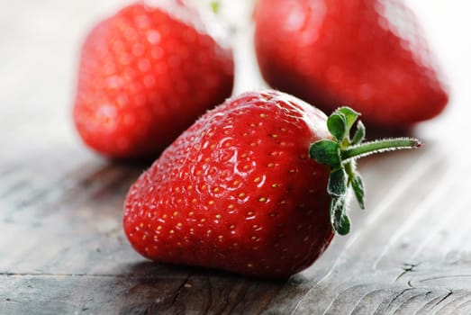 Strawberries on rustick wooden table