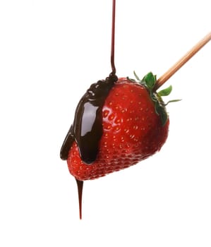 Pouring chocolate over fresh yummy strawberry