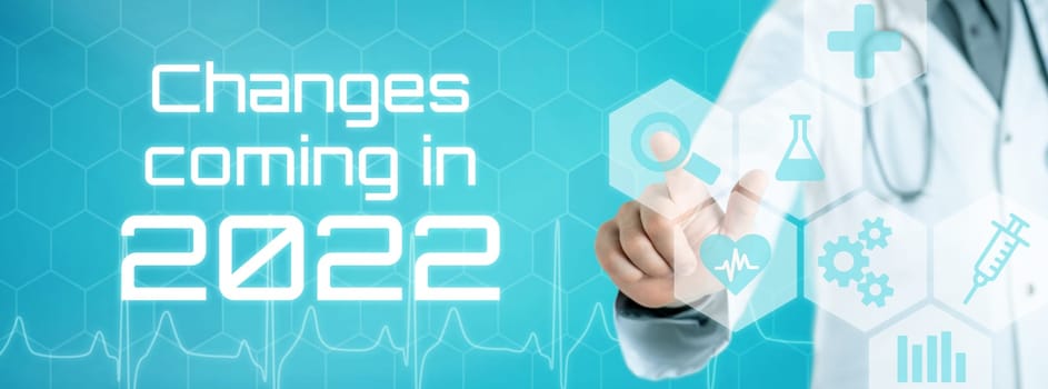 Doctor touching an icon on a futuristic interface - Changes coming in 2022