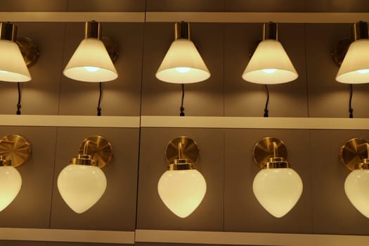 many lamps sconces are hung in a row and lit in the interior