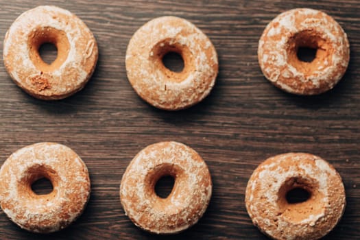 Beautiful Many Bagels and Gingerbreads Lie on a Brown Background