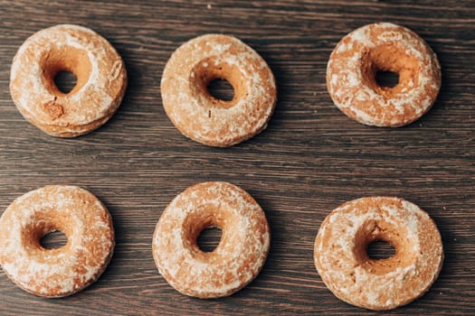 Beautiful Many Bagels and Gingerbreads Lie on a Brown Background