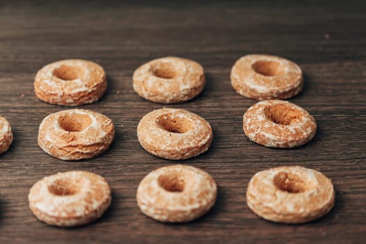 Beautiful Many Bagels and Gingerbreads Lie on a Brown Background