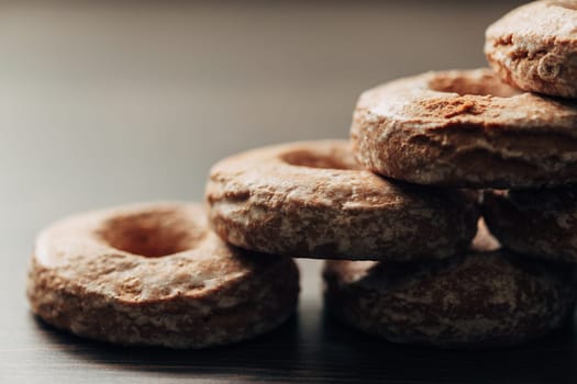 Beautiful Many Bagels and Gingerbreads Lie on a Brown Background
