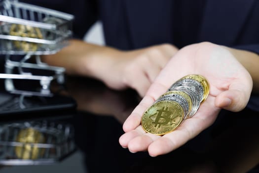 Closeup image of a business women holding and giving golden color bitcoins