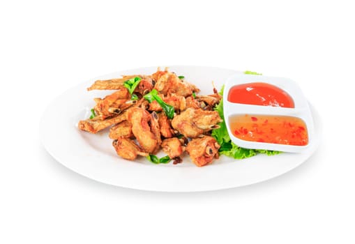 Fried chicken wings with sauce in white plate on white background
