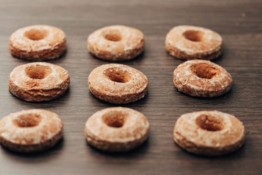 Beautiful Many Bagels and Gingerbreads Lie on a Brown Background