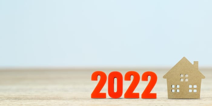 House model and number 2022 on table for finance and banking concept with copy space