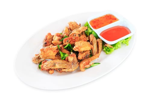 Fried chicken wings with sauce in white plate on white background