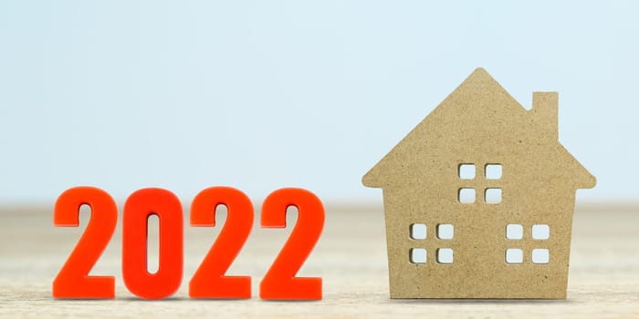 House model and number 2022 on table for finance and banking concept with copy space