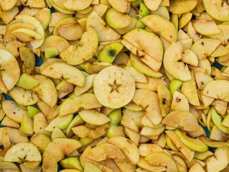Sliced green fruit apple slices for drying. Fruit drying. Apple juice. Agricultural gardening. Vitamin dessert. Healthy eating. Home kitchen. Cooking food. Grocery product.
