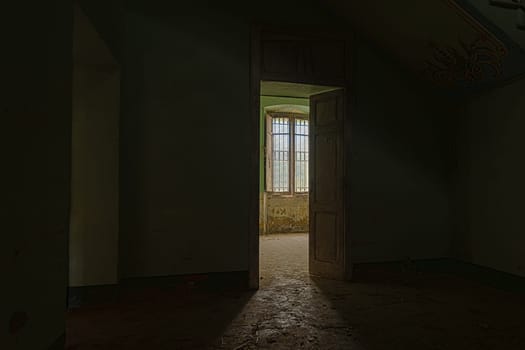 Interior of a decaying abandoned house. Art nouveau colors. Window openings. Mystery and darkness. long exposure times.