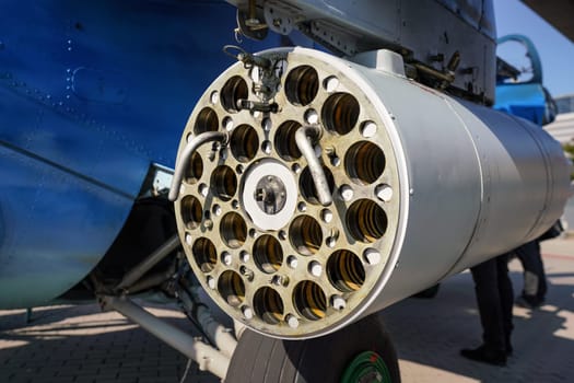 Military combat helicopter side gun or cannon, detail view from behind with tube holes for ammunition.