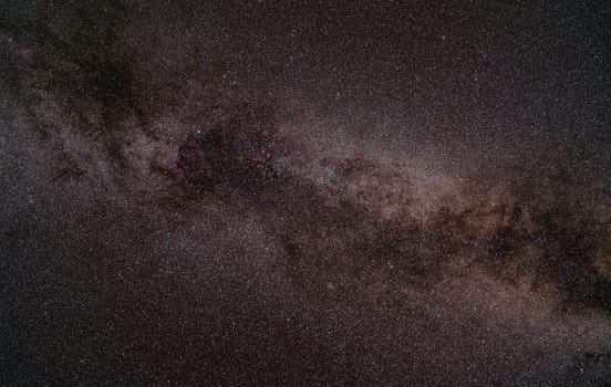 Night summer sky with milky way near swan constellation, North America nebula nebula faintly visible. Long exposure stacked photo.