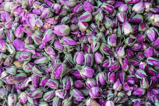 Pile of dried rose flowers used as natural fragrances displayed on souk - traditional street market in Morocco.