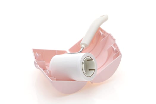 close up of sticky roller cleaning, housework and housekeeping concept