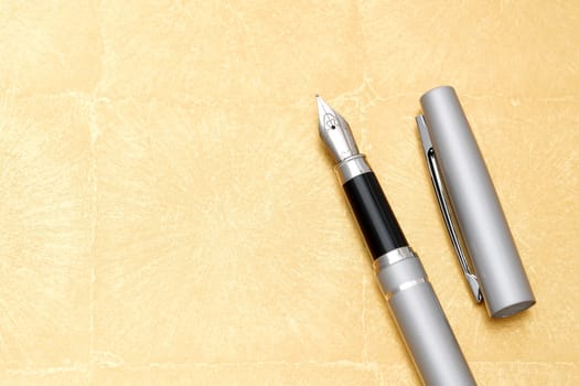 beautiful details of a fountain pen on golden table