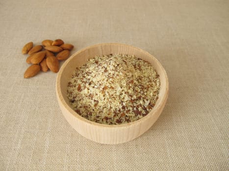 Unpeeled ground almonds in a wooden bowl