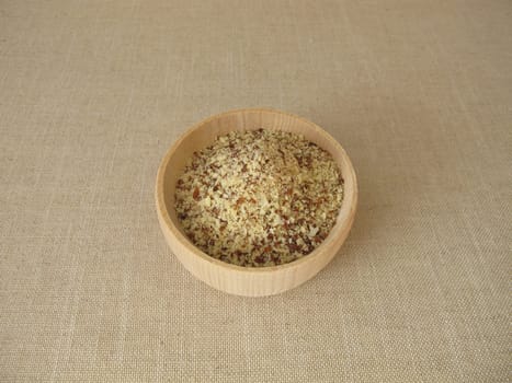 Unpeeled ground almonds in a wooden bowl