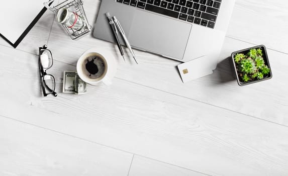 Stationery and gadgets on wooden background. Copy space. Flat lay.