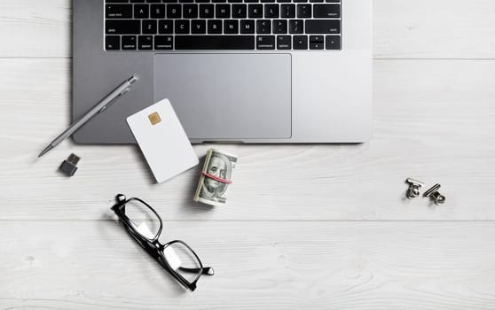 Laptop and office supplies on wooden background. Online shopping concept.