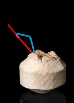 Young coconut isolated on a black background with reflection