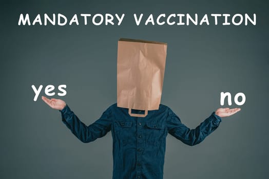 Mandatory vaccination, yes or no, german language, man with paper bag on his head, making a decision, covid-19, pandemic