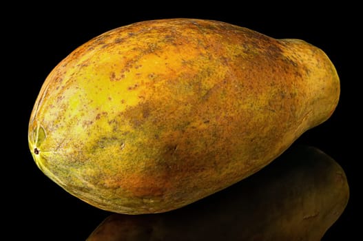 Papaya whole with reflection isolated on black background