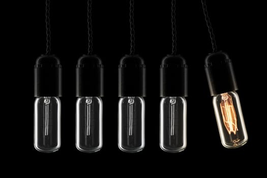 Newtons cradle pendulum with vintage style lightbulbs