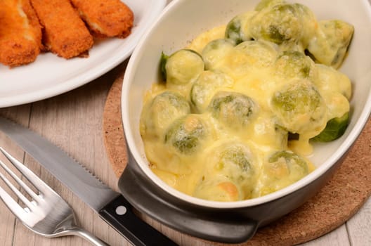 Roasted sprouts with cheese and fish sticks