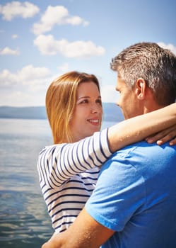 Pretty girl embracing young man by the seaside