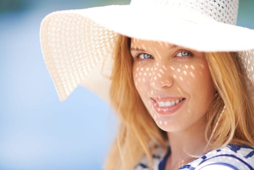 Cute female in sunhat looking at camera