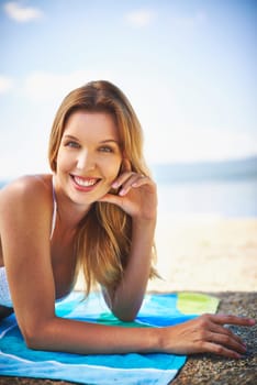 Happy girl in bikini sunbathing on the beach