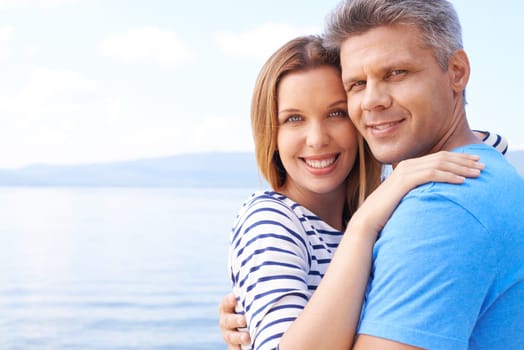 Affectionate man and woman enjoying summer vacation by sea