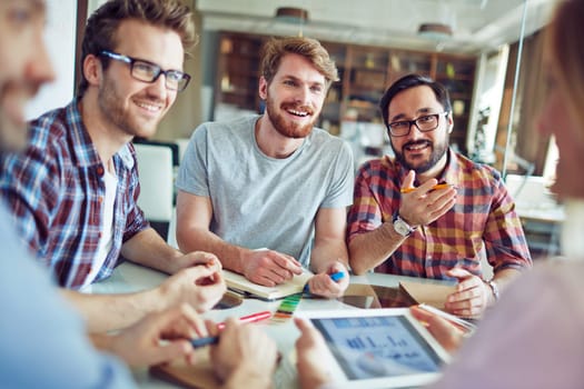Group of male employees talking to co-worker