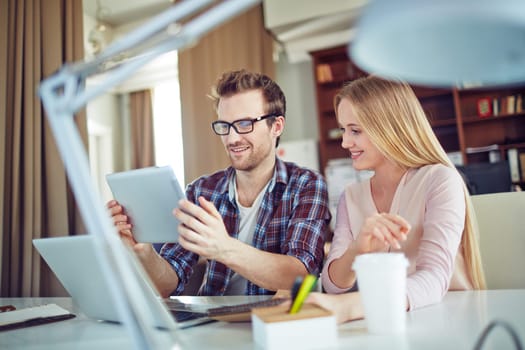 Modern business partners discussing electronic data in touchpad