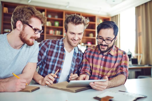 Friendly businessmen with touchpad browsing in the net