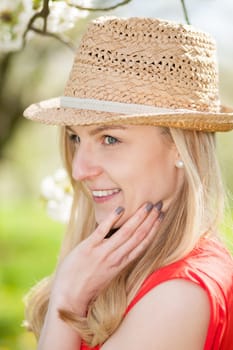 Young woman with straw hat in spring
