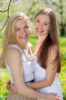 Girlfriends who hug each other in spring
