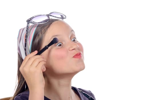 a little girl puts makeup of his mother on white