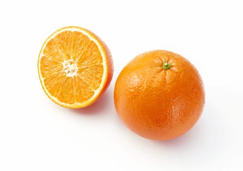 Oranges on white background. One whole and a half.