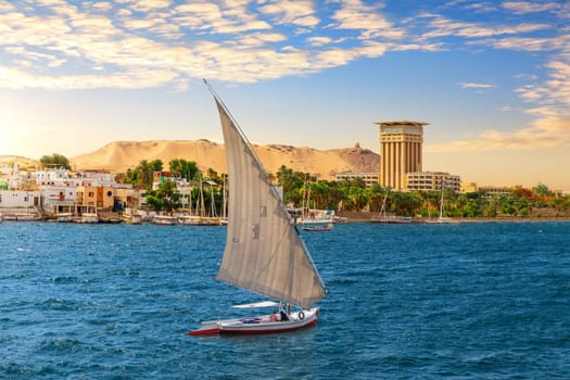 Felucca in the blue waters of Nile, Aswan city, Egypt.
