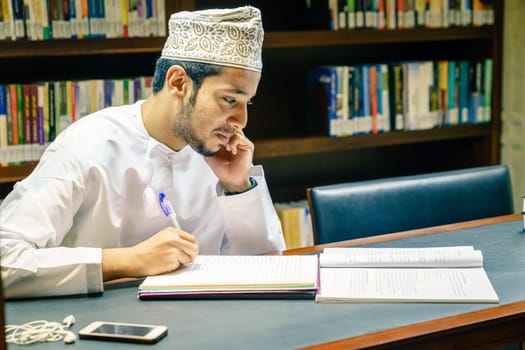 December 4, 2016, Muscat, Oman: a young muslim man is studying at the Mosque Muhammad al-Amin library