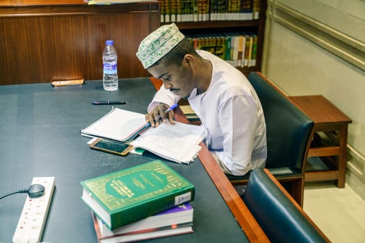 December 4, 2016, Muscat, Oman: a young muslim man is studying at the Mosque Muhammad al-Amin library