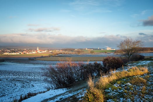 Landscape in autumn of village of Krensdorf in Burgenland with wall of fog