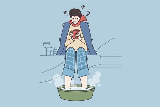 Fever and getting flu concept. Young sad man in warm clothes and scarf sitting with hot drink measuring temperature and making bath for foot vector illustration