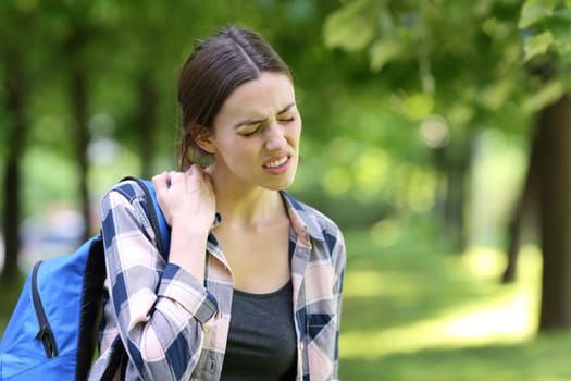 Student complaining about neck ache in a park