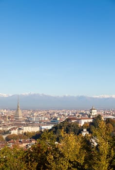 Turin, Italy - Circa November 2021: panorama with Alps and Mole Antonelliana,. Skyline of the symbol of Piedmont Region withi Monte dei Cappuccini - Cappuccini's Hill. Sunrise light.