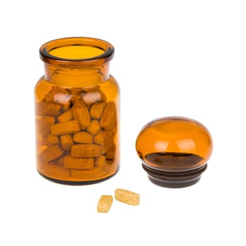 Full vintage apothecary bottle with pills and closed lid and spilled pills isolated on white background